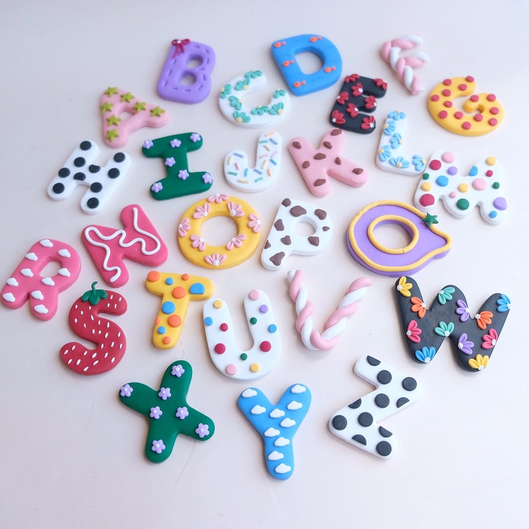 Bulk custom keychain order spread — multiple handmade clay pieces arranged before shipping across the Philippines